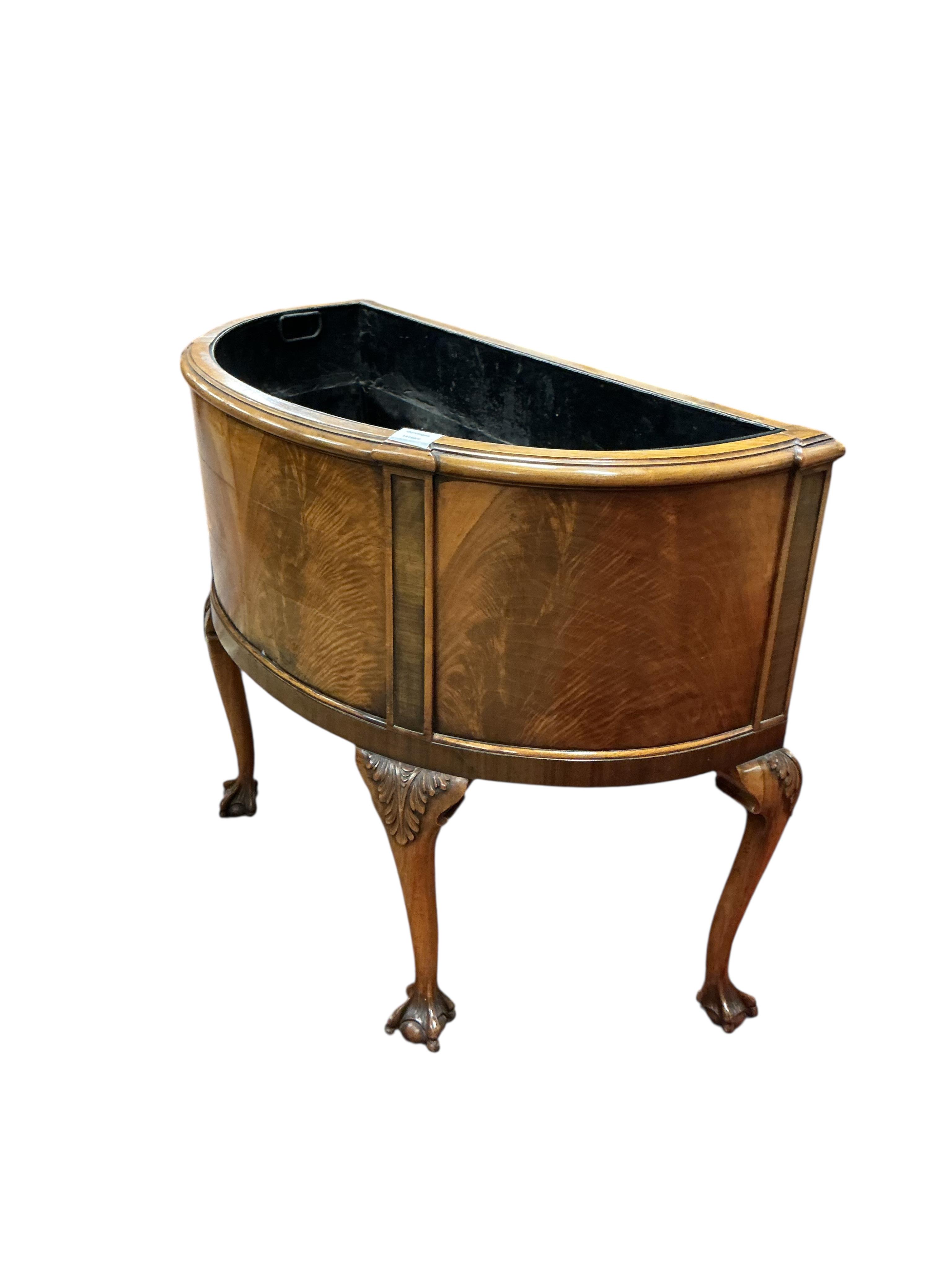A Queen Anne Revival walnut bowfront jardiniere, width 86cm, depth 40cm, height 69cm